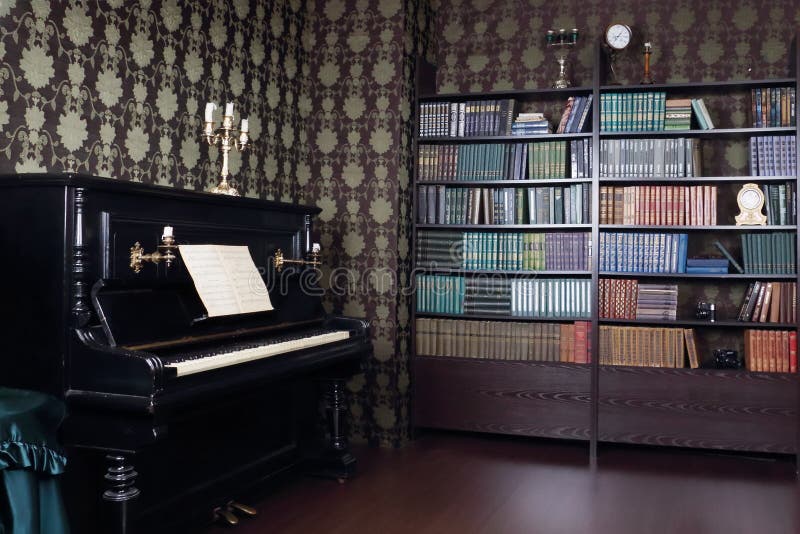 Interior of room with book shelves and piano