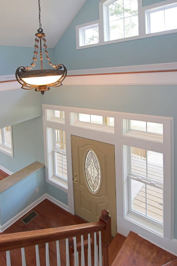 Interior view of home entry with lots of windows and staircase. Interior view of home entry with lots of windows and staircase