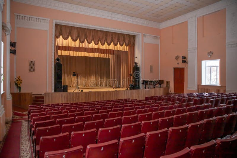 Interior view of an empty theater hall with red seats and stage before performance. Poltava, Ukraine, March 2026 royalty free stock photo