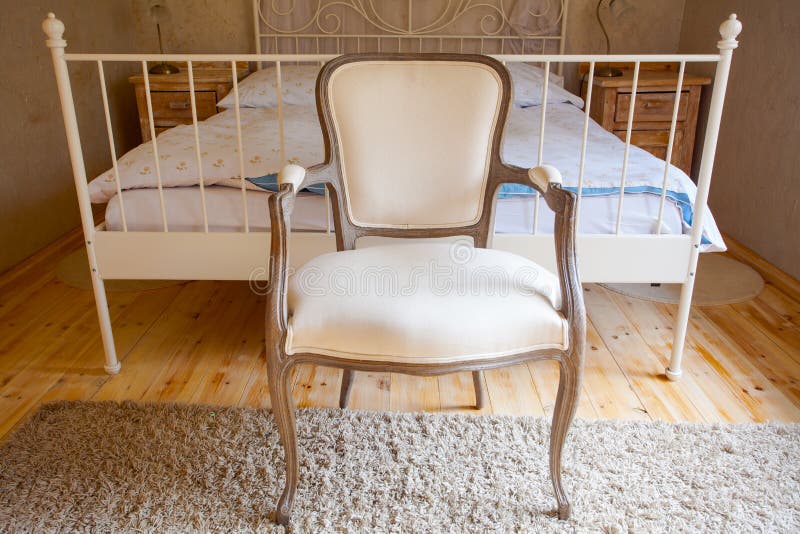 Interior of vintage bedroom. Bed and retro chair.