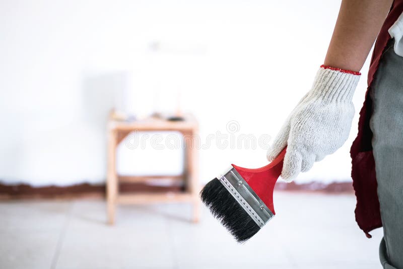 Interior Working, Painter Hand in White Glove Painting Wall with Stock