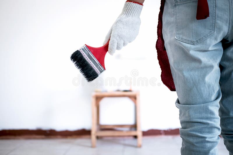 Interior Working, Painter Hand in White Glove Painting Wall with Stock