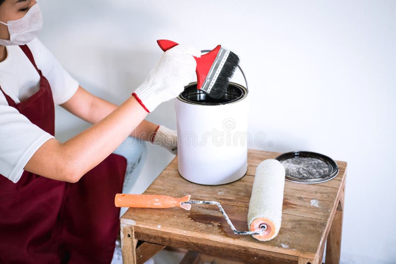 Interior Working, Painter Hand in White Glove Painting Wall with Stock