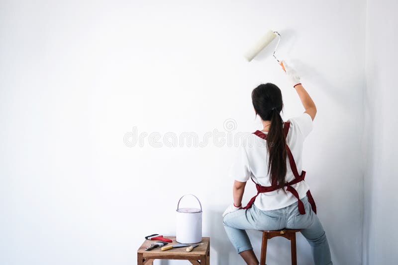 Interior Working, Painter Hand in White Glove Painting Wall with Stock