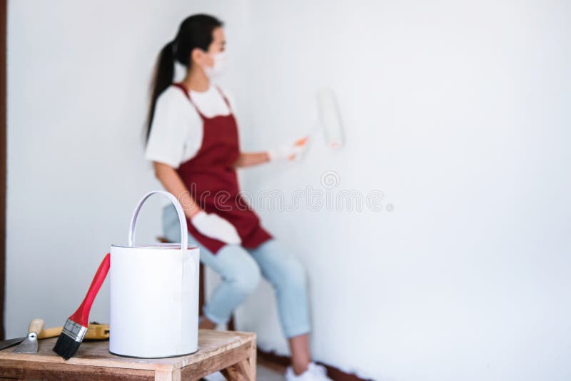 Interior Working, Painter Hand in White Glove Painting Wall with Stock