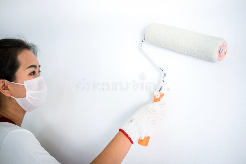 Interior Working, Painter Hand in White Glove Painting Wall with Stock