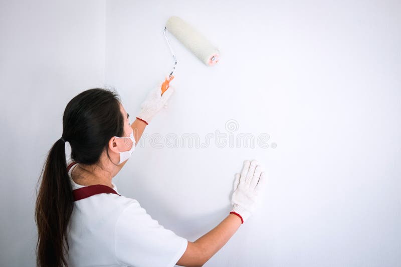 Interior Working, Painter Hand in White Glove Painting Wall with Stock