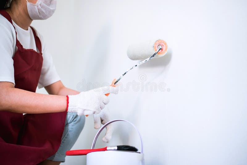 Interior Working, Painter Hand in White Glove Painting Wall with Stock
