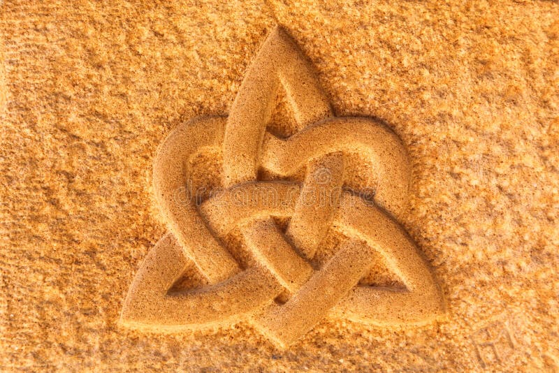 Interlaced triquetra with heart on a stone wall. Ancient pagan celtic images stock images, royalty-free photos and pictures