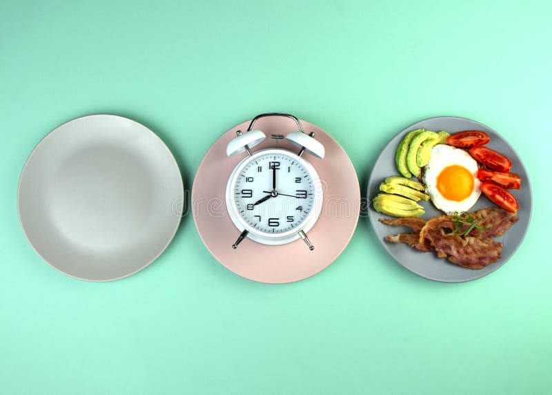 Intermittent fasting concept with empty colorful plates. Time to lose weight , eating control or time to diet concept. Healthy ketogenic breakfast. Intermittent fasting concept with empty colorful plates. Time to lose weight , eating control or time to diet concept. Healthy ketogenic breakfast