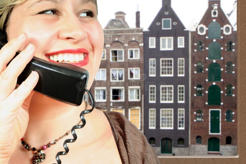 Woman makes an international phone call in Amsterdam. Woman makes an international phone call in Amsterdam