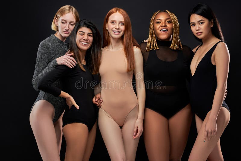 Three diverse women embracing, showcasing beauty in simple