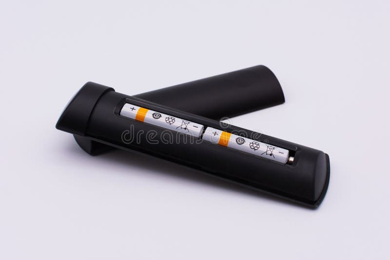 International recycling symbols on two batteries inserted into remote control royalty free stock image