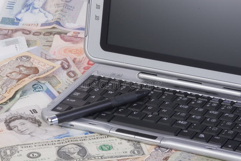 Dollar and sterling notes, notebook computer. Dollar and sterling notes, notebook computer