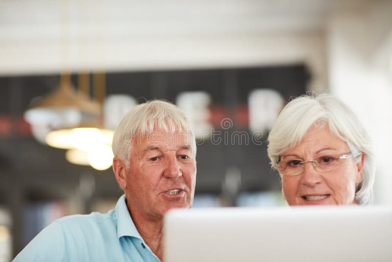 The internet made life so much easier for us. a senior couple using a laptop together. royalty free stock photos
