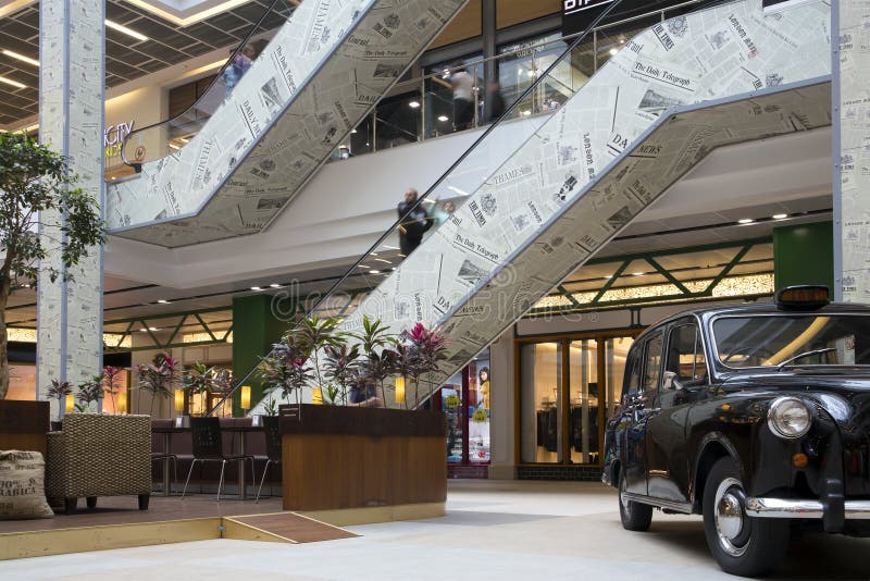 Interno di grande puttana moderna con le scale mobili, il self-service e la retro automobile esibita immagini stock Interno di grande puttana moderna con le scale mobili, il self-service e la retro automobile esibita immagini stock