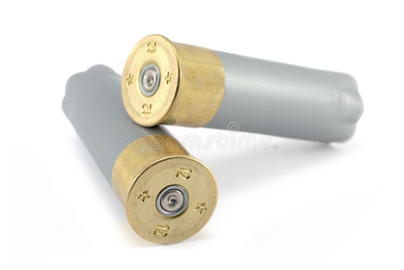 A 12 gauge shotgun shell isolated on a white background. A 12 gauge shotgun shell isolated on a white background.