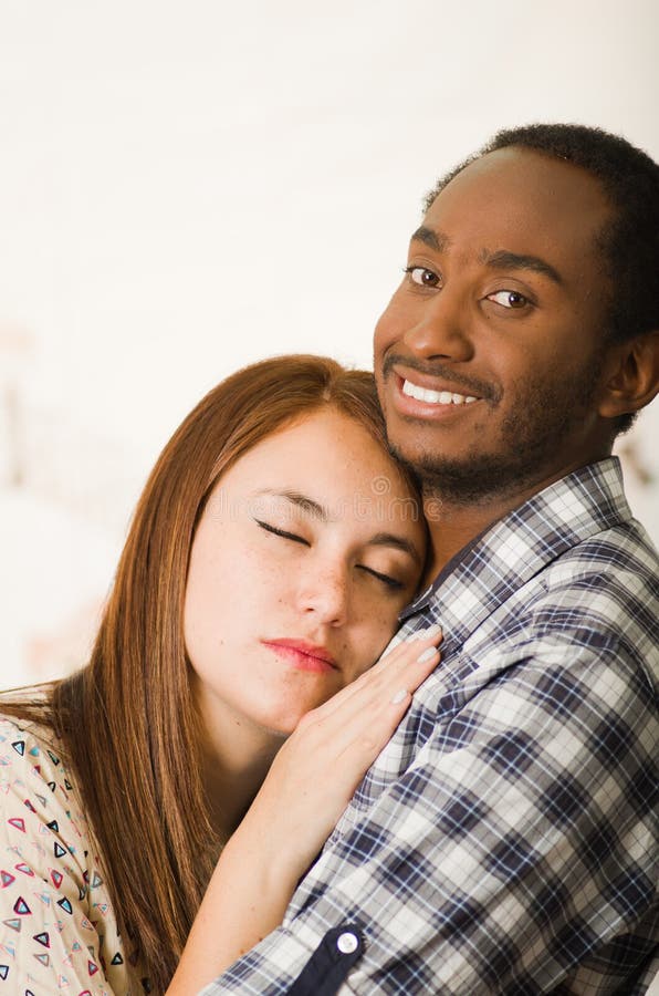 Interracial Charming Couple Wearing Casual Clothes Posing While Embracing Intimately She Has