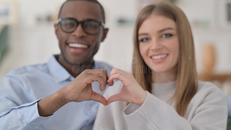 Interracial Couple Holding Hands Together In Heart Shape Stock Image