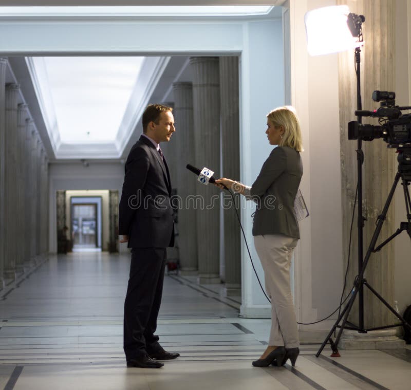 Interview with a politician. Reporter interviews a politician in the building of the Polish government royalty free stock image Interview with a politician. Reporter interviews a politician in the building of the Polish government royalty free stock image