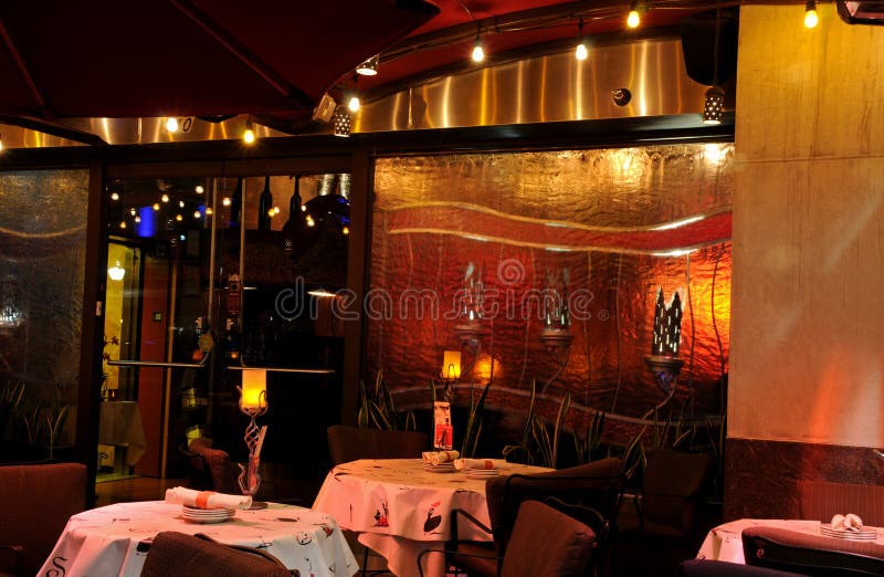 Interior of intimate restaurant with soft lighting.