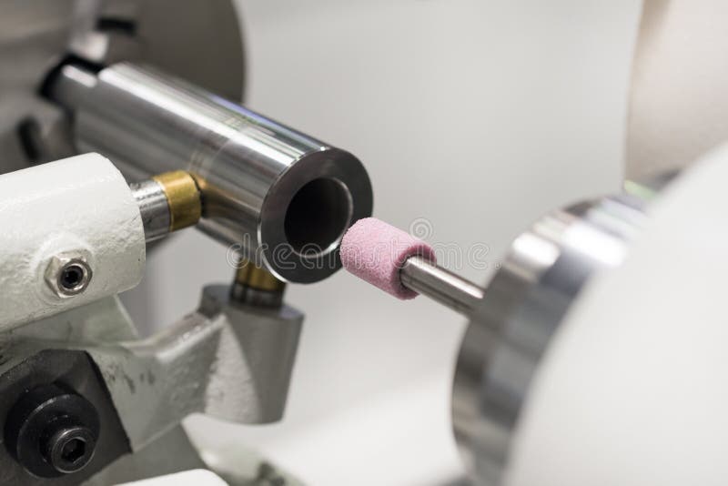 Intragrinding machine during operation. There grinding inner sleeve hole. Closeup machine tool stock images, royalty-free photos and pictures