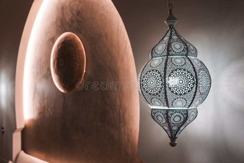Intricate Moroccan Lantern Casting Shadows in Boutique Hotel stock image
