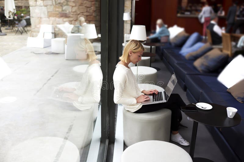 Introduction au clavier moderne de femme d'affaires sur le filet-livre tout en travaillant dans l'intérieur de studio de grenier photo libre de droits Introduction au clavier moderne de femme d'affaires sur le filet-livre tout en travaillant dans l'intérieur de studio de grenier photo libre de droits
