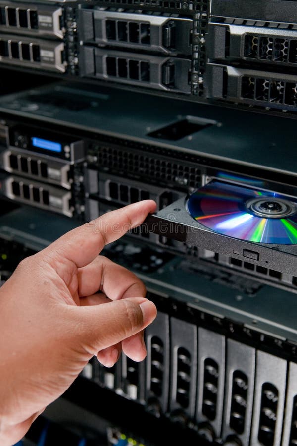 Picture of person inserting cd-rom into server. Picture of person inserting cd-rom into server