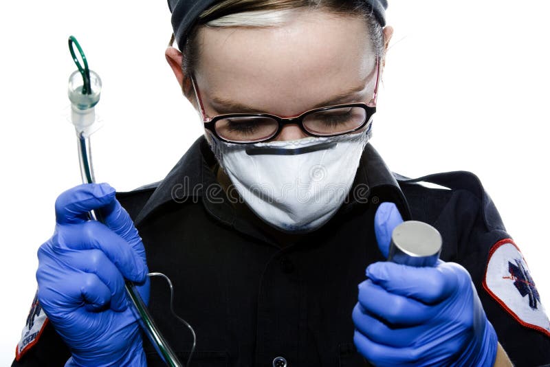 Paramedic intubating a person in the back of an ambulance. Paramedic intubating a person in the back of an ambulance