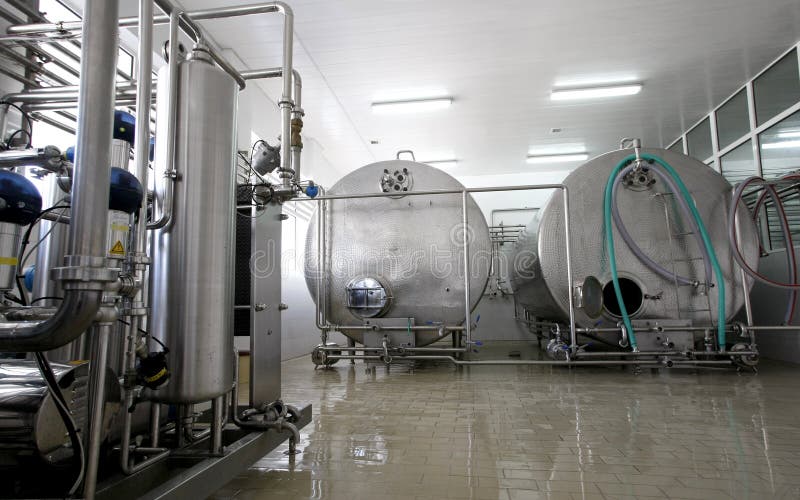 Stainless steel controlled pressure tanks in dairy factory. Stainless steel controlled pressure tanks in dairy factory
