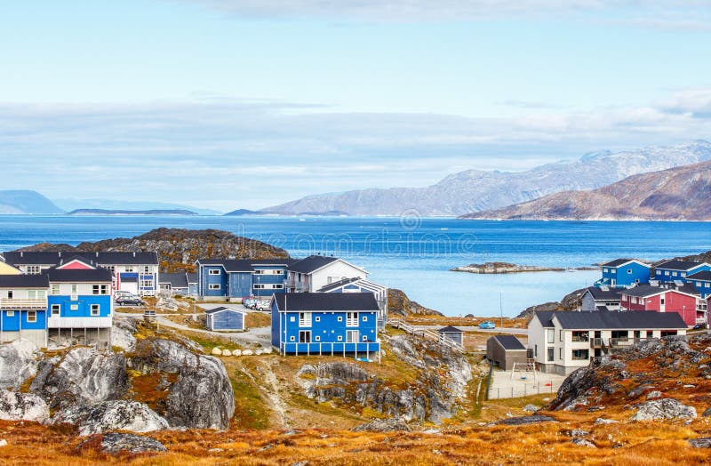 Inuit houses and cottages in residential district of Nuuk city with fjord and mountains in the background, Greenland