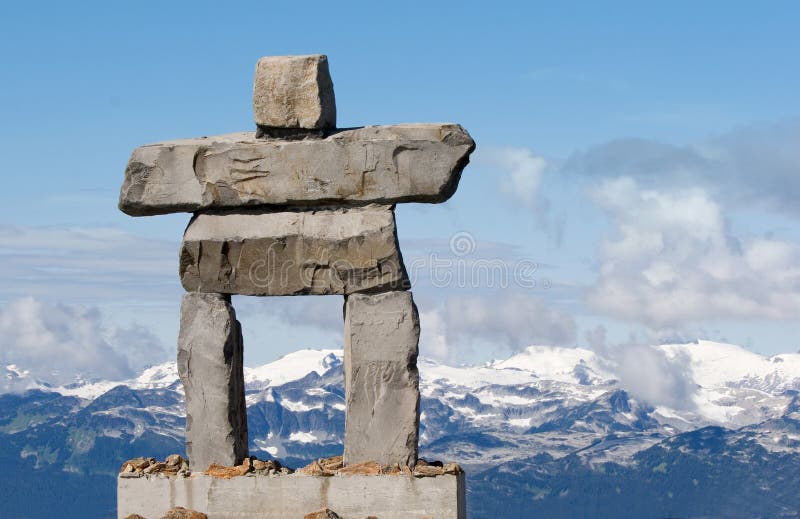 Giant rock inukshuk with mountains - inuit symbol for 'the way' & the 2010 winter olympics. Giant rock inukshuk with mountains - inuit symbol for 'the way' & the 2010 winter olympics