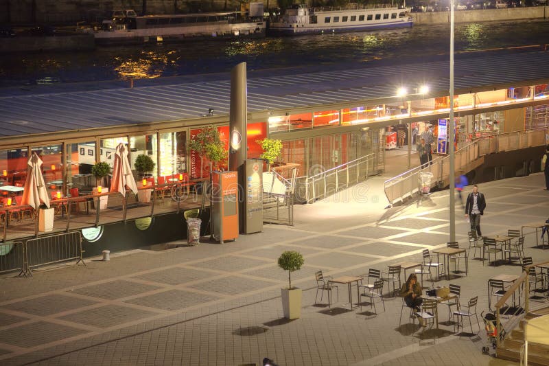 Night urban landscape. Embankment of the river Seine and little cafes on her shore. Night urban landscape. Embankment of the river Seine and little cafes on her shore