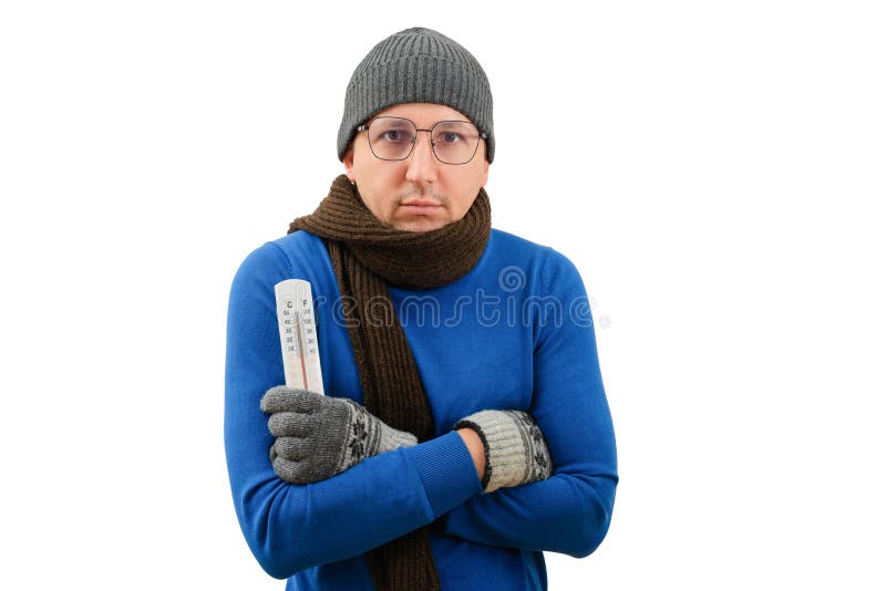 Cold winter season. A man in warm clothes with a thermometer in his hands looks at the camera on a white background. Cold winter season. A man in warm clothes with a thermometer in his hands looks at the camera on a white background.