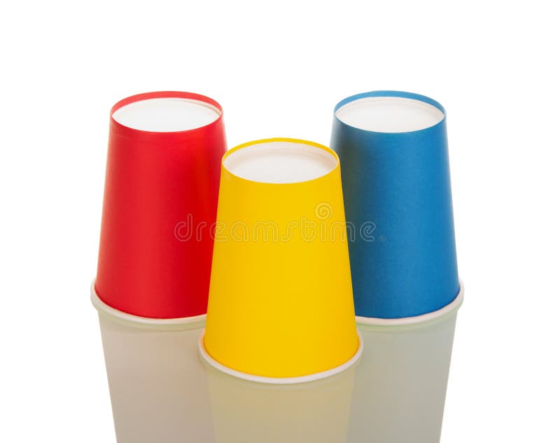 Inverted red, yellow and blue disposable tumbler isolated on white