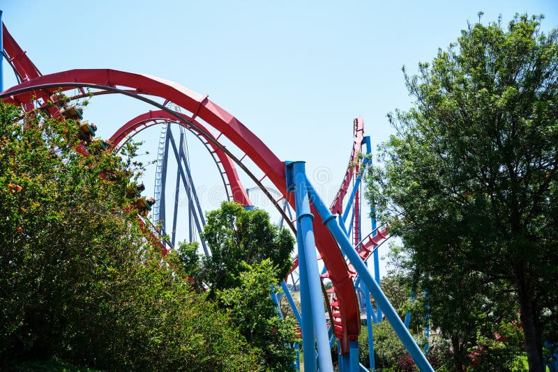 Inverted roller coaster with narrow metal rails, an ideal summer day to enjoy vacations royalty free stock image