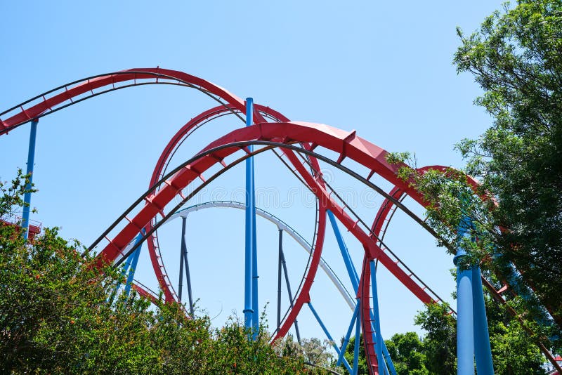 Inverted roller coaster with narrow metal rails, an ideal summer day to enjoy vacations stock image