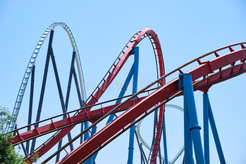 Inverted roller coaster with narrow metal rails, an ideal summer day to enjoy vacations stock photography