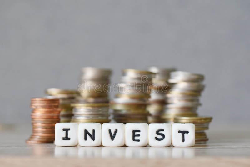 Invest and a coin on wooden table background, invest business economy concept of money and finance investments stock images