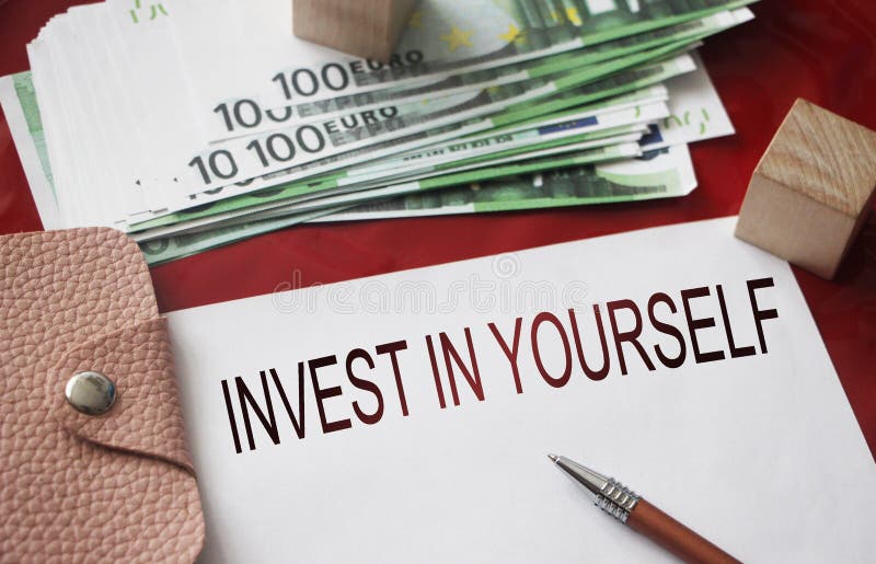 Invest in Yourself on copybook, 100 Euro bills, wallet, pen. career concept