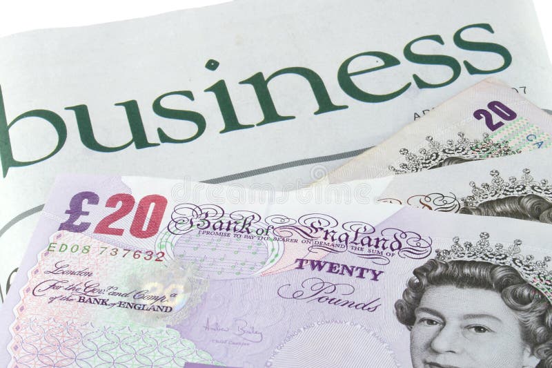 Business section of a newspaper and British pounds sterling. Business section of a newspaper and British pounds sterling