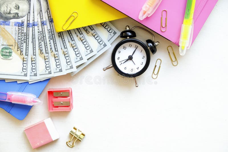Investing time and money into education concept. Different school supplies, banknotes. Top view, close up. royalty free stock photo Investing time and money into education concept. Different school supplies, banknotes. Top view, close up. royalty free stock photo