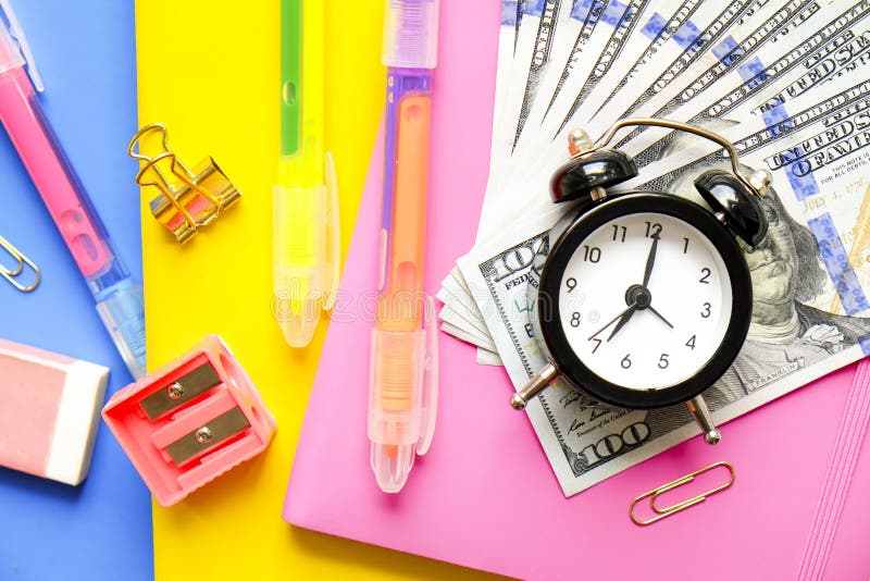 Investing time and money into education concept. Different school supplies, banknotes. Top view, close up. royalty free stock image Investing time and money into education concept. Different school supplies, banknotes. Top view, close up. royalty free stock image