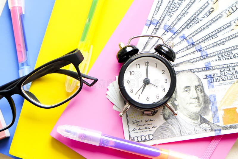 Investing time and money into education concept. Different school supplies, banknotes. Top view, close up. stock images Investing time and money into education concept. Different school supplies, banknotes. Top view, close up. stock images