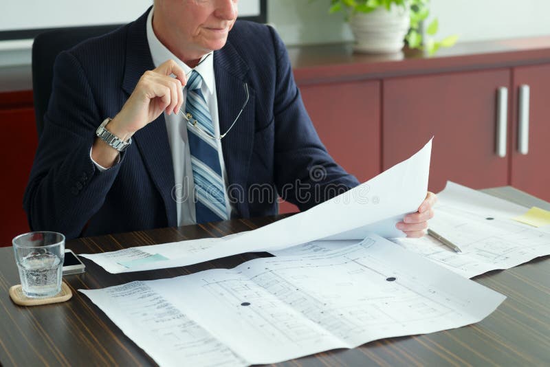 Investor with blueprint stock photography Investor with blueprint stock photography