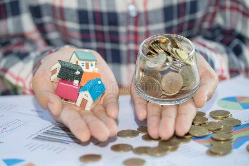Investor show hand holding a model home and coin , Saving money royalty free stock photo Investor show hand holding a model home and coin , Saving money royalty free stock photo