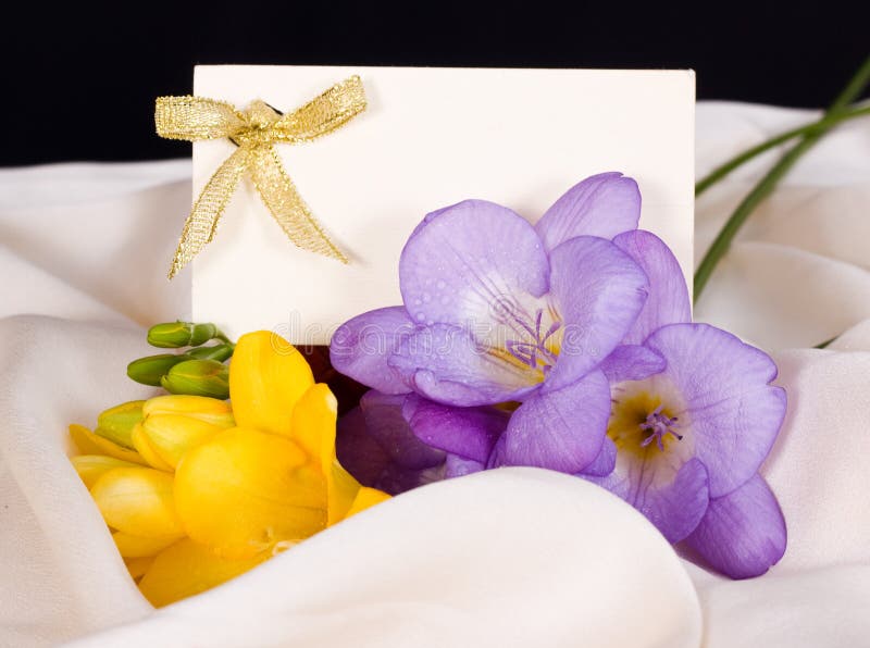 Invitation cards and flowers on delicate silk