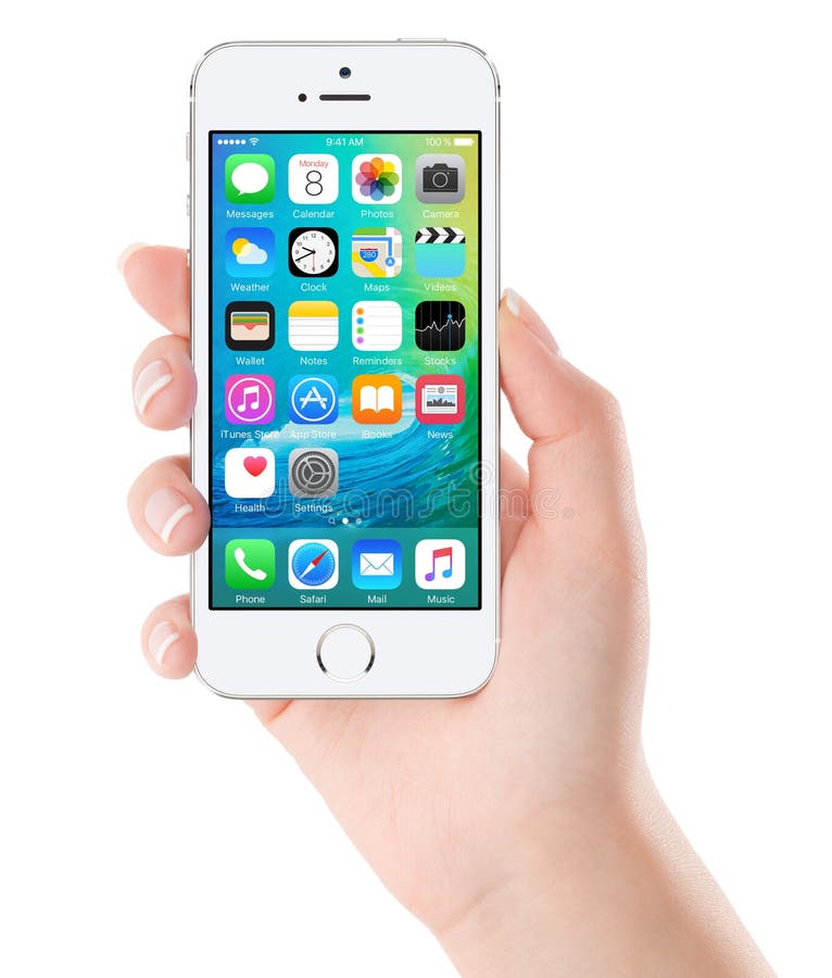 IOS 9 homescreen on the white Apple iPhone 5s display in female hand. iOS 9 is a mobile operating system created and developed by Apple Inc. Isolated on white background. Bulgaria - February 02, 2015.