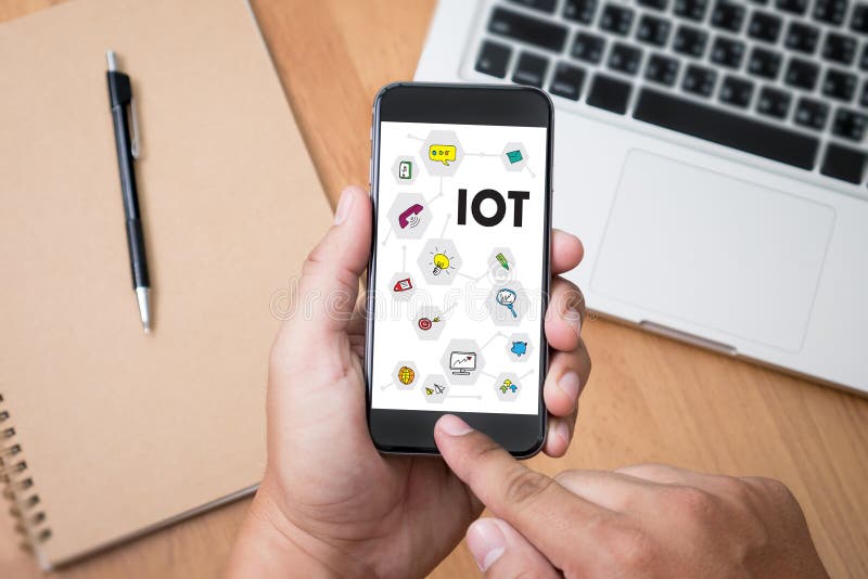 IOT business man hand working and internet of things (IoT) word stock photos